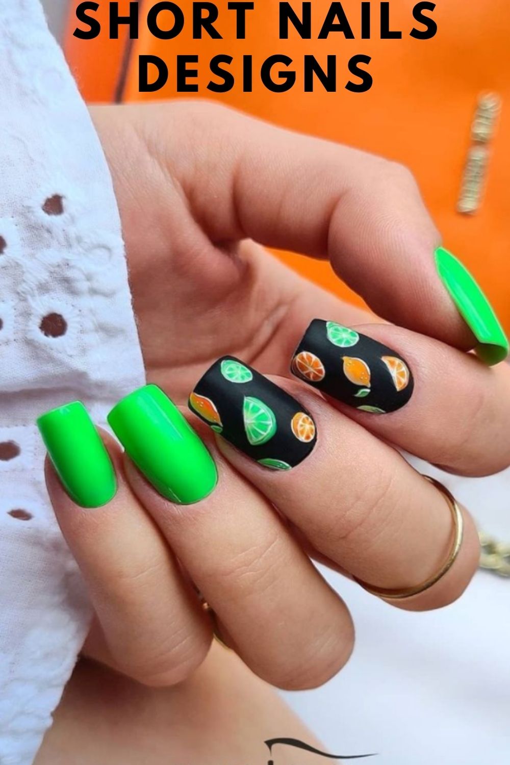 Green and black nails with lemon