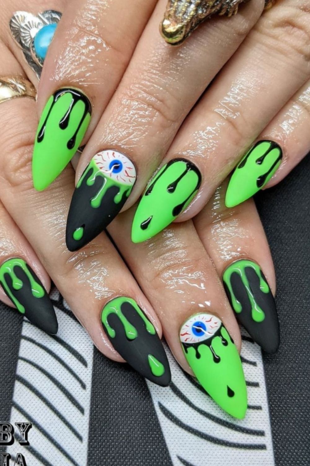 Neon and black almond nails with eyes